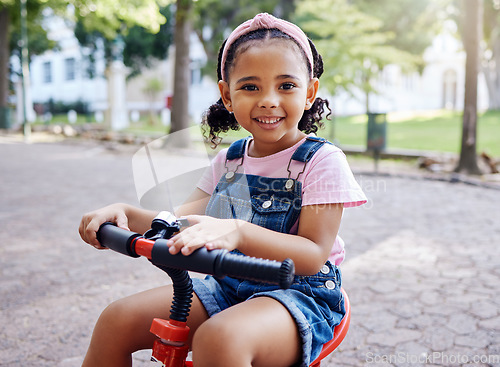 Image of Portrait, young girl on bike in park and happy child outdoor with nature and freedom, smile while riding. Travel, happiness and adventure, growth and childhood with family day out and cycling mockup