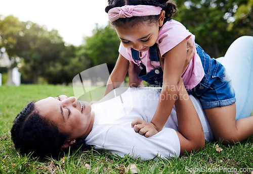 Image of Mother, daughter and playing on grass, relax and laughing while bonding and having fun at a park. Mama, girl and game on a forest floor, joy and smile while enjoying a happy moment on the weekend