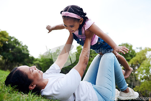 Image of Black family, park and flying with a woman and girl having fun together while bonding on grass outdoor. Kids, love and nature with a mother and daughter playing in a green garden outside in summer