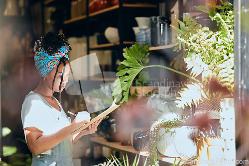 Image of Checklist, small business or black woman writing flowers for plants quality control or stock inventory. Agro management, store manager or entrepreneur planning or working on floral growth inspection