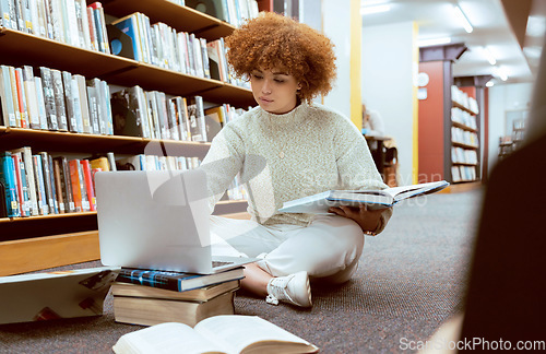 Image of Student learning, laptop research and black woman in library working on the floor with books. Reading, computer research and online study of a person with test and exam information for university