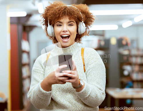 Image of University student, woman and phone for texting, library and headphones for streaming music, happy and online. Gen z girl, smartphone and social media app for chat communication on internet at campus