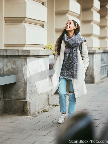 Image of Woman, walking or sightseeing city buildings in road, street or New York in morning commute, travel or holiday vacation. Smile, happy person and fashion tourist in warm and cool clothes on sidewalk