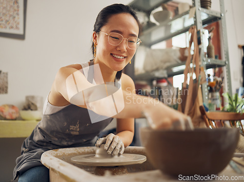 Image of Happy, pottery or woman in designer workshop working on cup sculpture or mug mold in small business. Smile, artistic girl or creative Japanese worker busy with handicraft products as entrepreneur