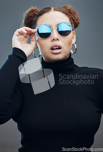 Image of Fashion, beauty and face of woman with sunglasses in studio for cosmetics, makeup and luxury style. Magazine model, designer brand and confident girl with accessories, trendy clothes and jewellery