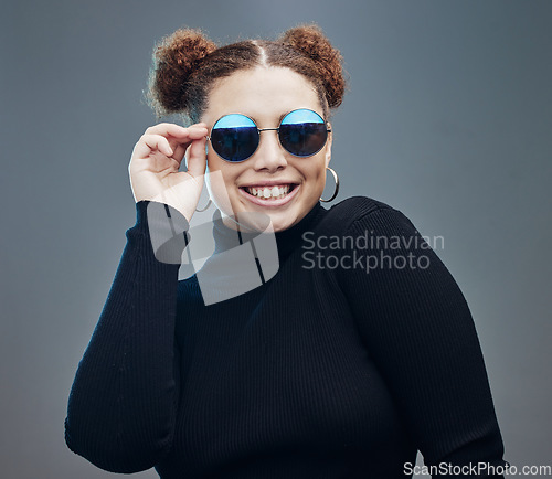 Image of Fashion, smile and woman with sunglasses for beauty cosmetics, makeup and luxury style in studio. Aesthetic, designer brand and confident girl with stylish accessories, trendy and edgy jewellery