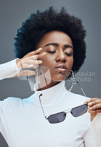 Image of Fashion, cosmetics and black woman with sunglasses in studio for stylish clothes, makeup and luxury style. Beauty model, designer brand and confident girl with accessories, trendy and edgy jewellery