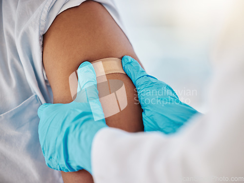 Image of Covid, vaccine and plaster on the arm of a black man patient in a hospital for an injection or healthcare. Doctor, medical and insurance with a male in a clinc for her corona virus vaccination