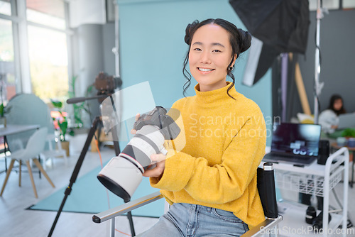 Image of Happy, photoshoot and portrait of a photographer with a camera for production, video and media. Creative, smile and an Asian woman in a studio for filming, shooting and working in photography