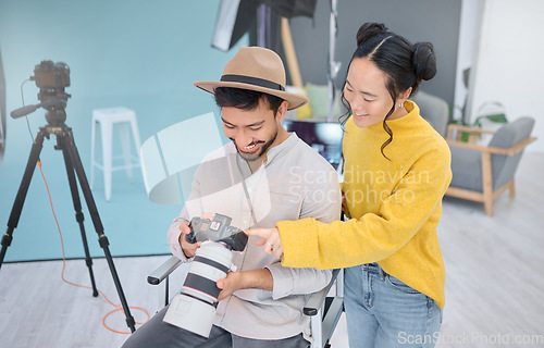 Image of Photography, photographer and model in discussion with a camera choosing a image from the photoshoot. Creative, art and young cameraman talking to woman to choose the best picture in artistic studio.