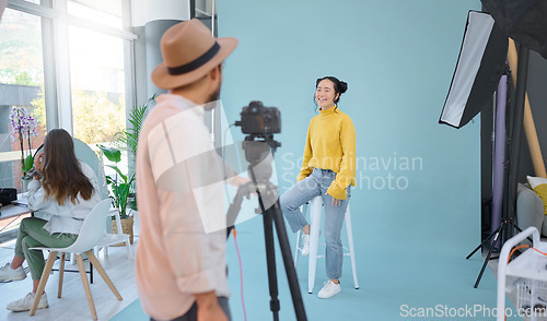 Image of Photographer, shoot and woman model in studio for professional, photo and posing on wall background. Photography, magazine and man taking pictures of asian girl on mockup, creative and contemporary