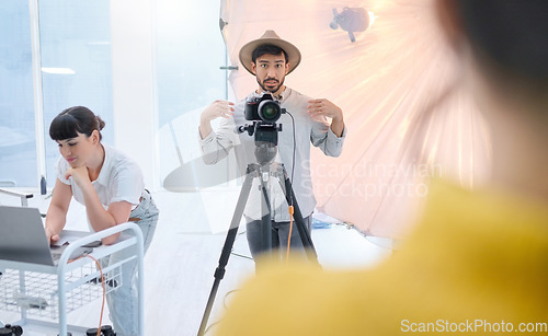 Image of Man, photographer and camera in studio with model showing poses, expression or style for photoshoot. Male in photography for idea, art or fashion working with client, dslr lens and stand for image