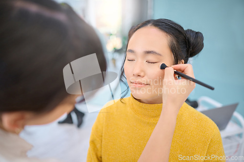 Image of Beauty, cosmetic and beautician doing makeup on a woman for a creative photoshoot in a studio. Cosmetics, art and stylist preparing a young Asian female model with a routine for a photography job.