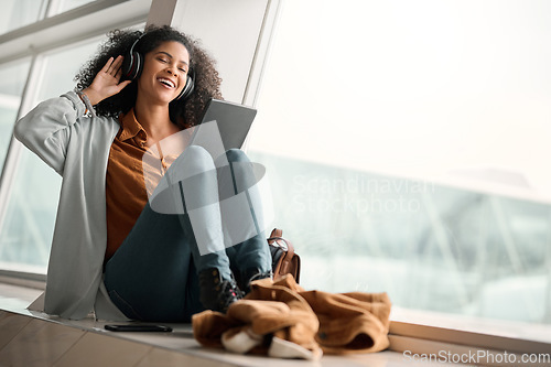 Image of Relax, travel or black woman on tablet and headphones for music, podcast or radio in airport lobby. Smile, mockup or happy girl on audio tech for communication, networking or social media network app