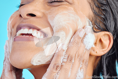 Image of Shower soap, happy face and black woman cleaning body with liquid for hydration, beauty healthcare or skincare hygiene. Self care studio, spa foam and relax model washing isolated on blue background