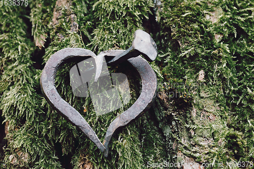 Image of forged heart and nail love concept