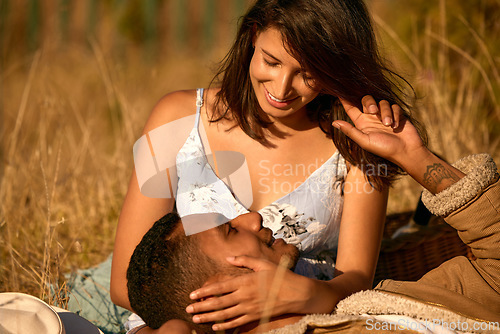 Image of Love, sunset and relax with couple in field for summer break, picnic and romantic date. Happy, smile and affectionate with man and woman lying in grass of countryside for travel, bonding and peace