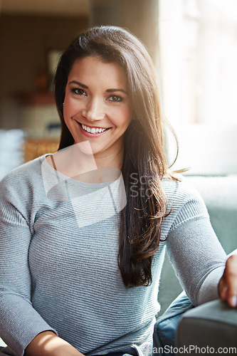 Image of Portrait, woman and relax on sofa, happiness and comfortable in living room, weekend break and smile at home. Young female, girl and on couch in lounge, happy and confidence with sunshine and calm