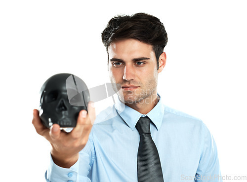 Image of Businessman, black skull in hand in studio for death, symbol and failure on white background. Mental health, man and skeleton head for hypnosis, emoji and bad luck, horror and end while isolated