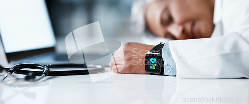Image of Tired doctor, woman and sleep in night with smartwatch, laptop and stethoscope on desk in clinic office. Healthcare burnout, senior medical expert and sleeping by computer table in hospital workspace