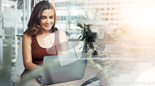 Image of Woman, laptop and typing in coffee shop, cafe or restaurant for internet blogging, internet research or education course. Smile, happy and entrepreneur on technology with lens flare or freelance app