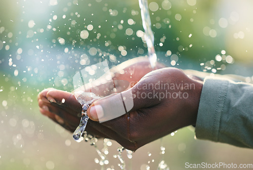 Image of Hands, splash and man with water in nature for outdoor washing, cleaning or body hygiene. Natural, organic and African male hand with aqua to wash or clean to prevent germs, dirt or dust outside.