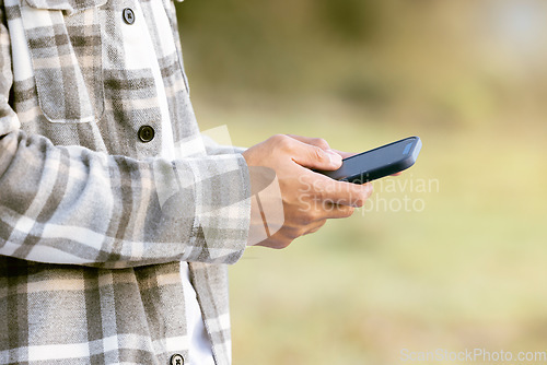 Image of Phone outdoor, man hands and park of a person typing on social media and mobile communication. 5g connection, website and media technology scroll of a male reading with blurred background in nature