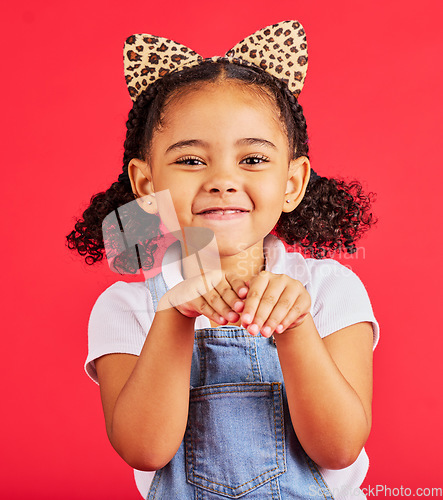 Image of Girl, portrait and leopard headband in studio for fancy dress, pretend play and imagination in red background. Happy children, animal print fashion and hands excited for fun, happiness and cute pose