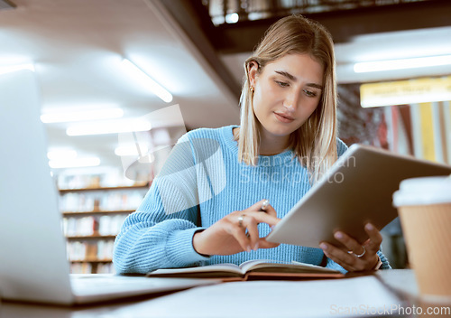 Image of Education, university and woman in library with tablet, research and books for school project or exam. Laptop, notebook and internet, college student studying with technology and elearning on campus.