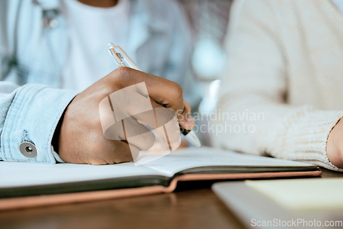 Image of Closeup, black man hand and writing in notebook at desk for studying, planning and support for goals. Student men, book and pen for brainstorming, vision or thinking together for university success