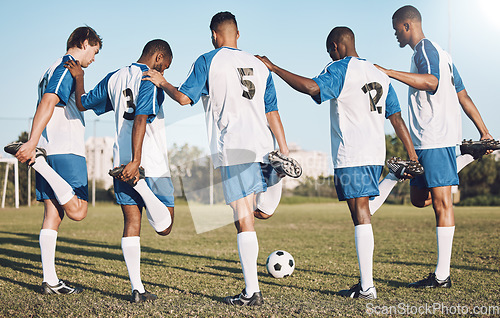 Image of Soccer, sports and stretching with a team outdoor on a field getting ready together for a competitive game. Football, fitness and warm up with a male sport group of friends on a pitch before a match