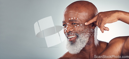 Image of Skincare, face cream and senior man in studio for wellness, beauty and grooming against grey background. Facial, skin and elderly model relax with luxury, cosmetics and wrinkle product while isolated