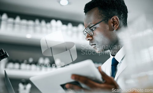 Image of Science, laboratory and black man with tablet for research, medical analysis and experiment results. Medicine, healthcare and scientist with digital tech for data analysis, lab study and innovation