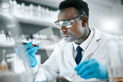 Image of Black man, research and tube for test sample, focus and thinking for cure, innovation and diagnosis. African American male, researcher or scientist with vial, data analysis or decision for experiment