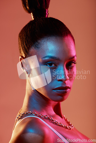 Image of Neon lighting, cyberpunk and portrait of a woman with makeup isolated on a brown studio background. Fashion, futuristic and face of a model with creative beauty, coametics and glow on a backdrop