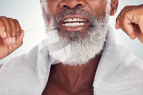 Image of Floss, dental and teeth of senior man isolated on white background for mouth wellness, self care and cleaning. African model or elderly person with product for tooth, gum and oral dentist healthcare