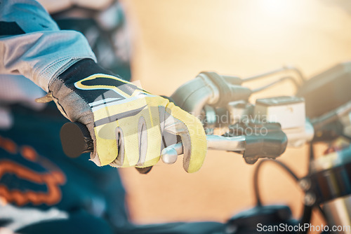 Image of Moto cross, glove hand and motorcycle with a athlete ready for adventure sport and competition. Motorbike drive training, dirt bike and sports of a man doing fitness challenge for performance