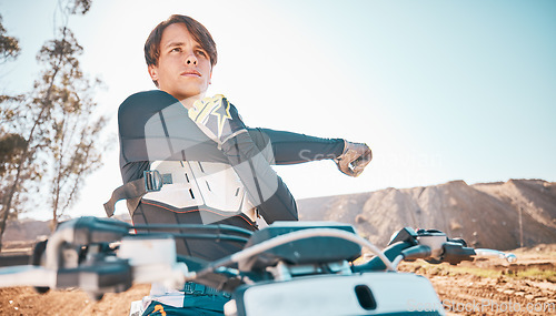 Image of Moto cross, arm stretching and man in nature on motorbike for competition workout. Desert ride, motorcycle training and exercise focus of an extreme motorbike sports athlete on a dirt road for sport