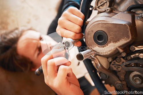 Image of Hands, mechanic and engine repairs working on motor with tools for racing, safety or mechanical part. Hand of engineer fixing motorbike, transport or transmission on automobile or vehicle in workshop