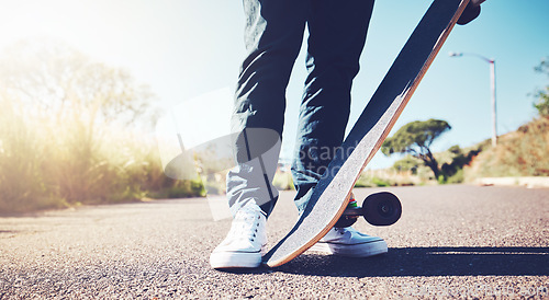 Image of Skateboard, road and person feet in sports training, learning or outdoor hobby in summer. Asphalt street, park and skater in skating activity, cardio or fitness with gen z, urban lifestyle or travel