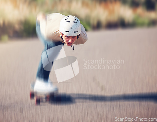 Image of Skateboard, blurred motion and speed with a sports man skating on an asphalt road outdoor for recreation. Skate, soft focus and fast with a male athlete or skater training outside on the street