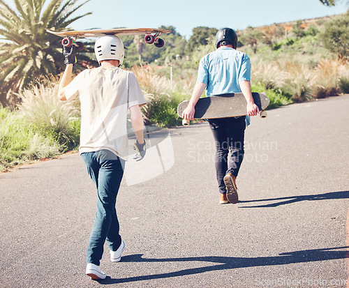 Image of Skateboard, sports and friends walking in road ready for adventure, freedom and leisure exercise on mountain. Friendship, skateboarding and skater men with longboard for exercise, skating and fitness