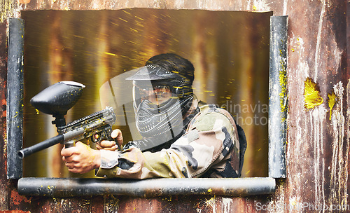 Image of Paintball, gun and camouflage with a sports man playing a military game for fun or training outdoor. War, soldier and target with a male athlete shooting a weapon outside during an army exercise