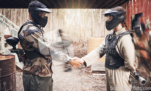 Image of Handshake, paintball team and congratulations or support, sports game on battlefield and partnership with agreement. Mask for safety, speed and gun, people together on shooting range with trust