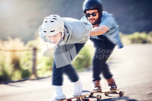 Image of Skating, longboard and friends riding fast on a road, racing downhill with skateboard and helmet for safety. Extreme sports, speed and people or skateboarder in action on mountain pass