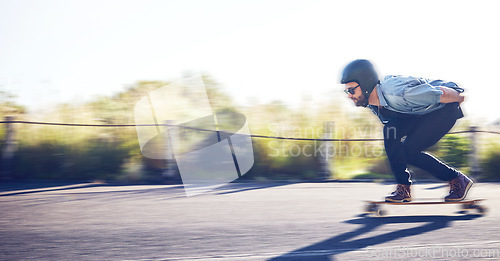 Image of Sports, skateboard and man riding on road for fitness, exercise and wellness. Training, freedom and male skater on board moving with fast speed, skateboarding and skating outdoors for action workout
