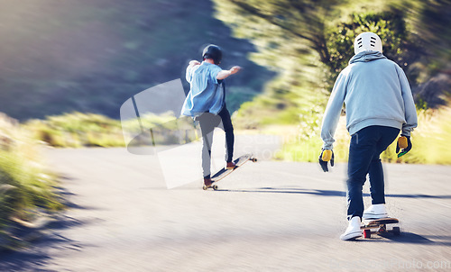 Image of Friends, speed and longboard skating in road, men racing downhill with skateboard and helmet for safety. Extreme sports adventure, skateboarding street race and skateboarder tricks on mountain pass.