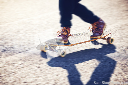 Image of Feet, skateboard and man skating on road for fitness, exercise and wellness. Training sports, shoes and legs of male skater on board, skateboarding or riding outdoors for balance or workout on street