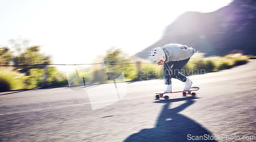 Image of Fast, sports and man skateboarding in the road for freedom, travel and urban action in Norway. Fun, competition and skateboarder blur with speed, motion and moving on a skateboard in the street