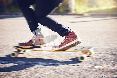 Image of Skateboard, feet and man skating on road for fitness, exercise and wellness. Training sports, shoes and legs of male skater on board, skateboarding or riding outdoors for balance or workout on street